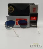 Lunettes de soleil Ray-Ban Aviator RB3025 monture métallique dorée avec verres dégradés gris-bleu, étui et boîte d'origine.
