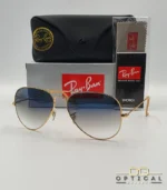 Lunettes de soleil Ray-Ban Aviator RB3025 monture métallique dorée avec verres dégradés bleus, étui et boîte d'origine.