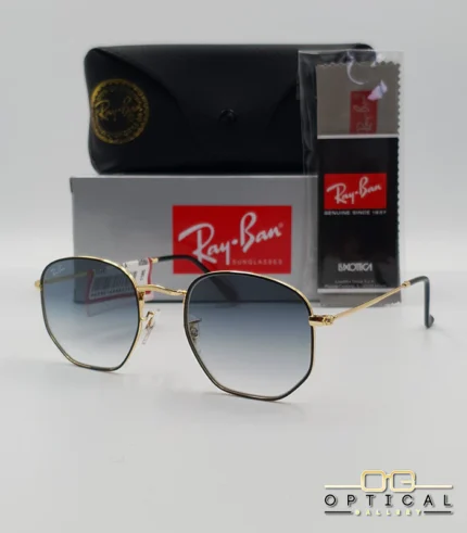 Lunettes de soleil Ray-Ban Hexagonal Flat Lenses RB3548N monture bicolore en métal doré et cerclage noir avec verres dégradés gris-bleu, étui et boîte d'origine.