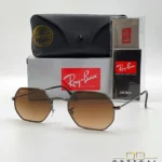 Lunettes de soleil Ray-Ban Octagonal RB3556 marron bronze avec verres dégradés marrons, étui noir, boîte grise et livret Luxottica.