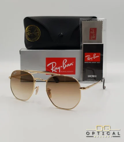 Lunettes de soleil Ray-Ban Marshal II RB3648M dorées avec verres dégradés marrons, étui noir, boîte grise et livret de garantie chez Optical Gallery.